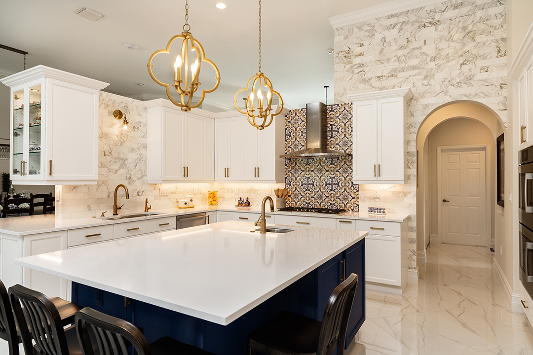 Beautiful white, gold, and blue kitchen with marble floors