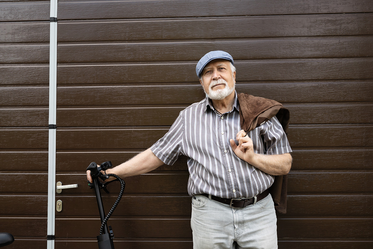 elderly man stands near the door and is healthy