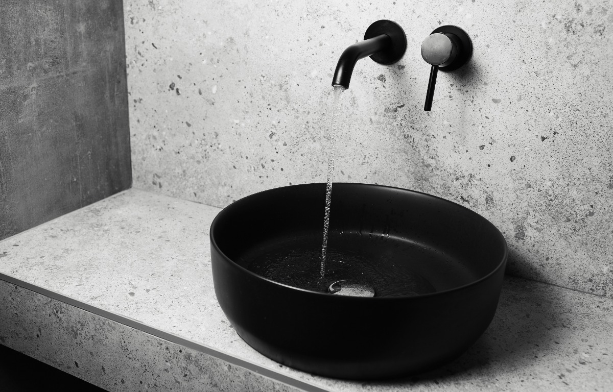 matte black sink with water faucet running