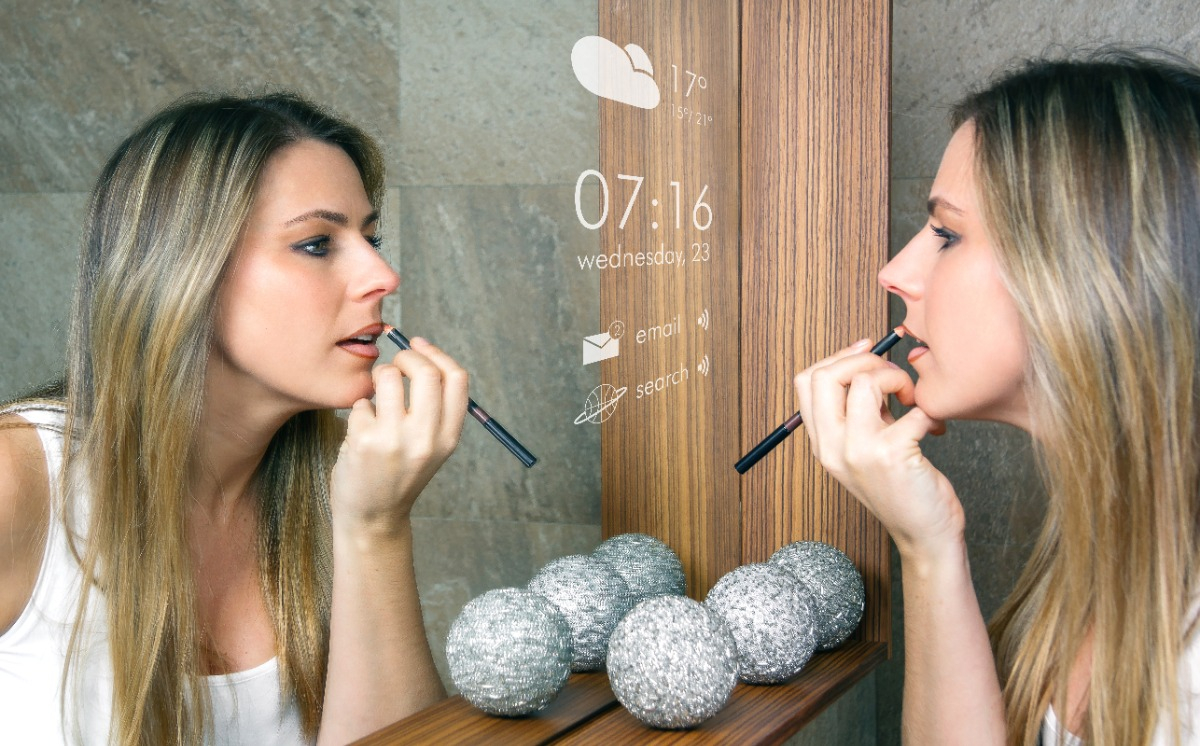 smart mirror with women doing makeup in front of it
